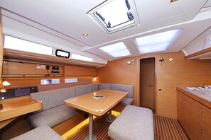 A compact galley with a table, seating, and a control panel. - Sun-kissed Sailing Adventure in Split-Dalmatia, Croatia (Trogir)