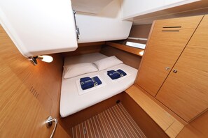 A compact cabin with a bed, storage cabinets, and a small seating area. - Sun-kissed Sailing Adventure in Split-Dalmatia, Croatia (Trogir)