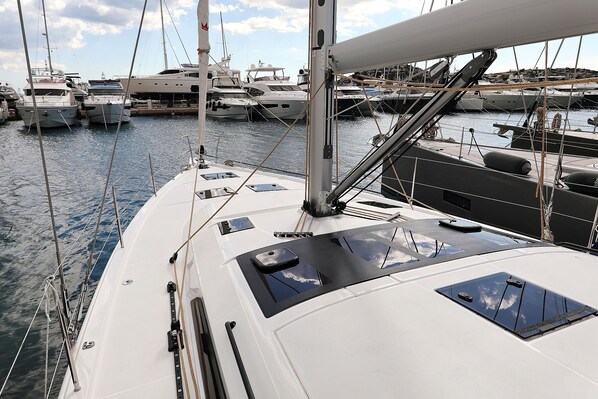 A marina with multiple yachts docked.