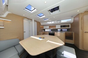 A compact kitchen with a microwave, stove, and sink. - Sibenik Sun and Beach Sailing Extravaganza (Tribunj)