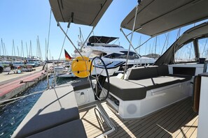 A marina with boats docked, a covered deck area, and a clear sky. - Sibenik Sun and Beach Sailing Extravaganza (Tribunj)