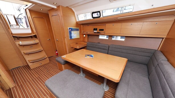 A compact, well-organized cabin with a wooden table, cushioned seating, and a small overhead shelf. - Sun-kissed Sailing Adventure in Split-Dalmatia, Croatia (Trogir)