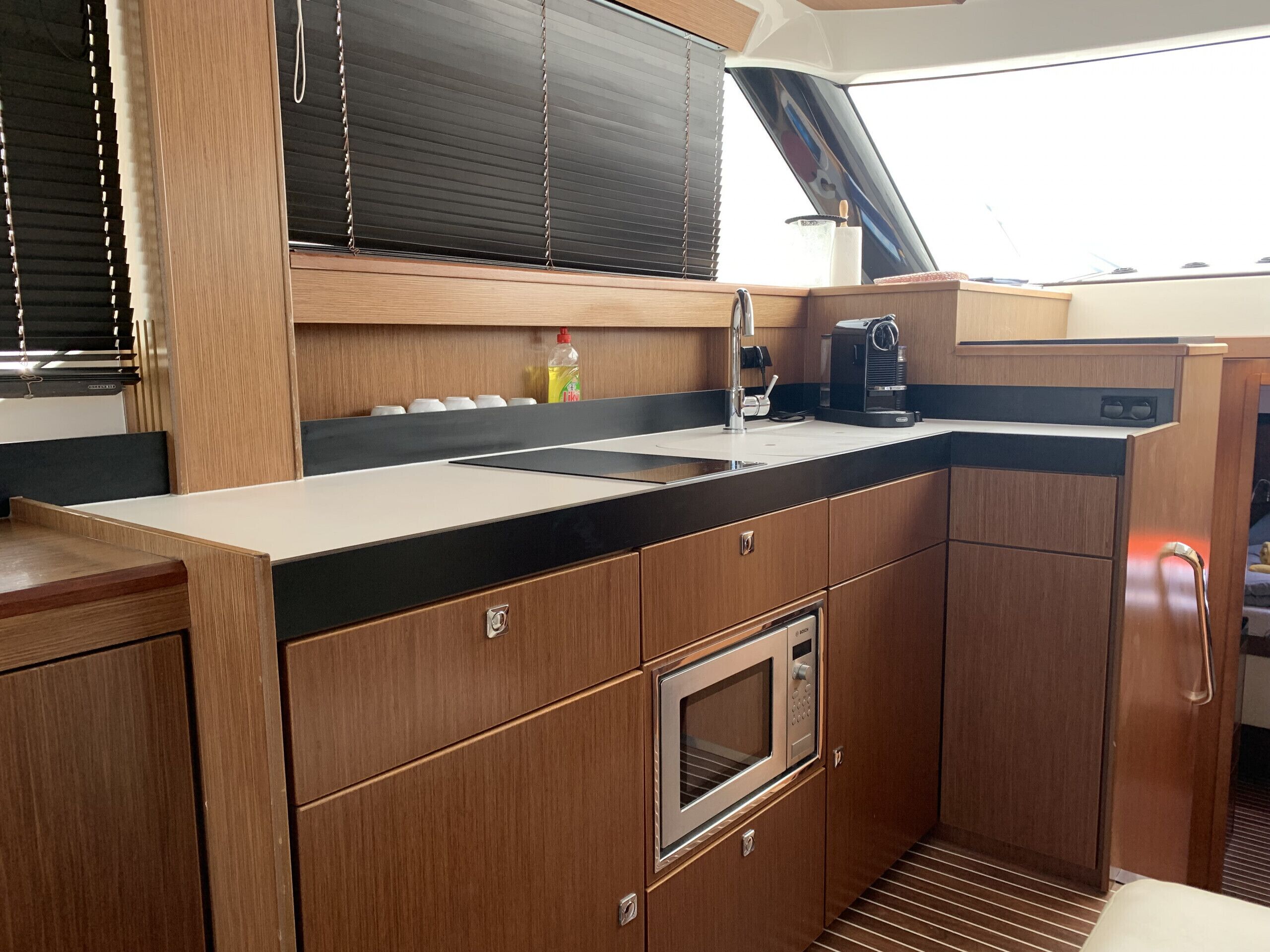 A compact kitchen with a sink, stove, and microwave.