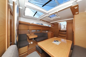 A compact, well-lit interior with a dining area, seating, and skylights. - Sun-kissed Sailing Adventure in Split-Dalmatia, Croatia (Trogir)