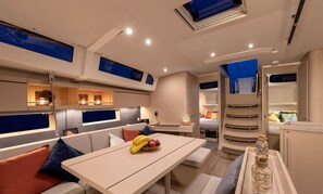 A compact, modern interior with a dining area, seating, and a kitchenette.