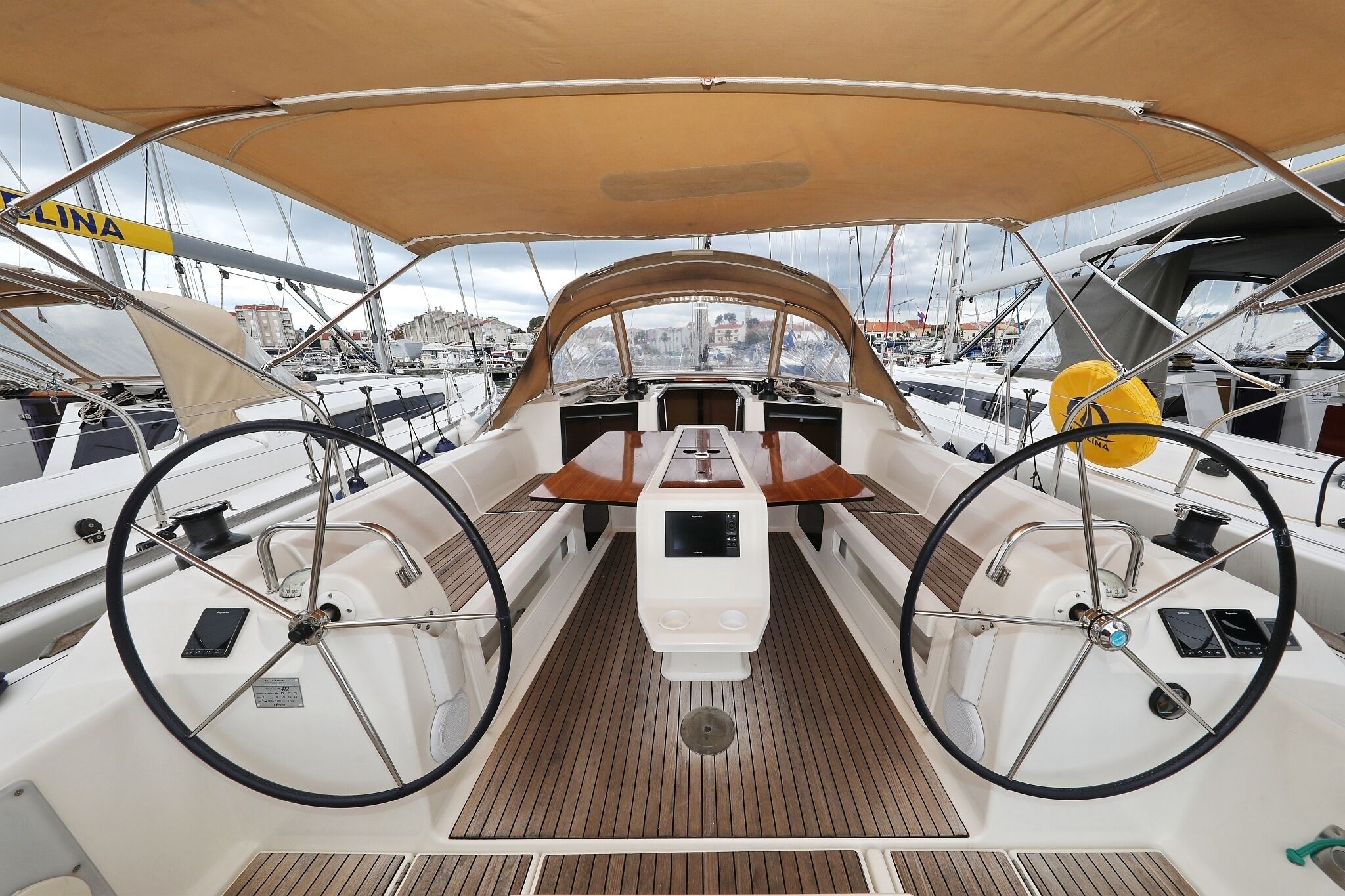 Un pont de bateau équipé d’un volant, d’un panneau de commande et d’un auvent au-dessus.