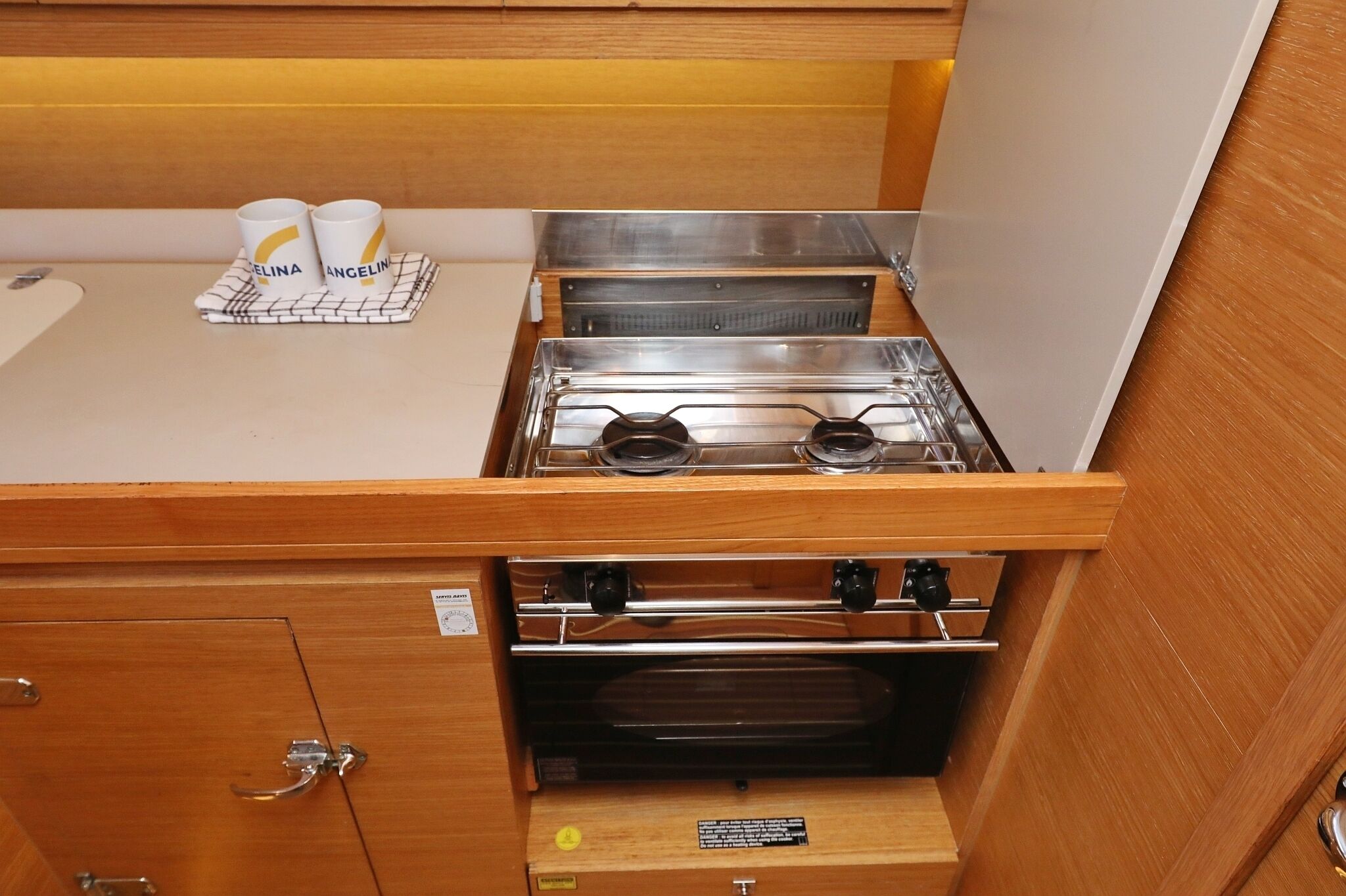 A compact kitchenette with a gas stove, oven, and a small countertop.