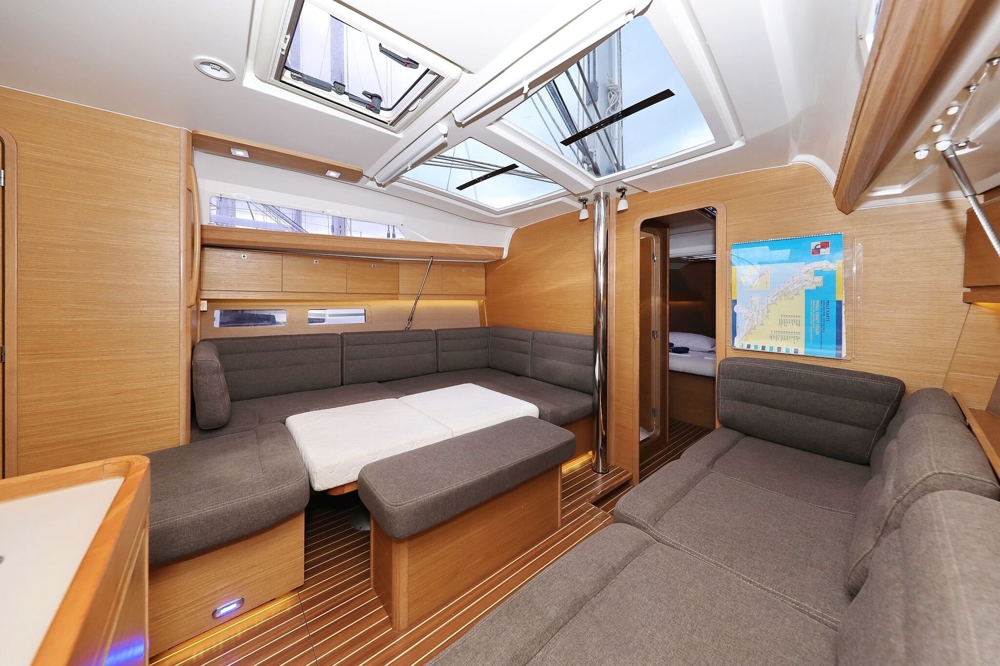 A compact, well-lit interior with a seating area, a table, and skylights.