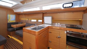 A compact galley with a sink, stove, and seating area. - Sun-kissed Sailing Adventure in Split-Dalmatia, Croatia (Trogir)