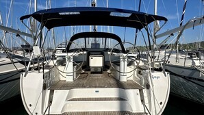 A boat deck with a steering wheel, control panel, and seating area. - Sun-Kissed Sailing Adventure in Zadar, Croatia (Bibinje)