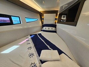 A narrow, well-lit cabin with a bed, a small window, and a control panel. - Sun-kissed Sailing Adventure in Split-Dalmatia, Croatia (Seget Donji)
