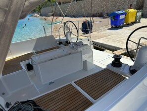 Ein Bootsdeck mit Blick auf Strand und Schwimmbad.