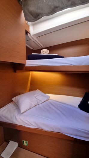 A bunk bed with a pillow and a rolled towel on the top bunk. - Sun-Kissed Sailing Adventure in Split, Croatia (Rogac)