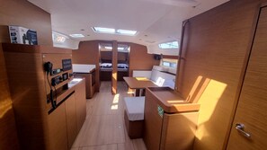 A compact interior with a kitchenette, seating area, and a small window. - Sun-Kissed Sailing Adventure in Split, Croatia (Rogac)