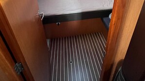 A compact, enclosed sleeping area with a skylight, a small window, and a metal grate floor. - Sun-Kissed Sailing Adventure in Zadar, Croatia (Bibinje)