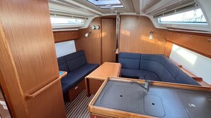 A compact, well-lit interior with a kitchenette, seating area, and skylights. - Sun-Kissed Sailing Adventure in Zadar, Croatia (Bibinje)