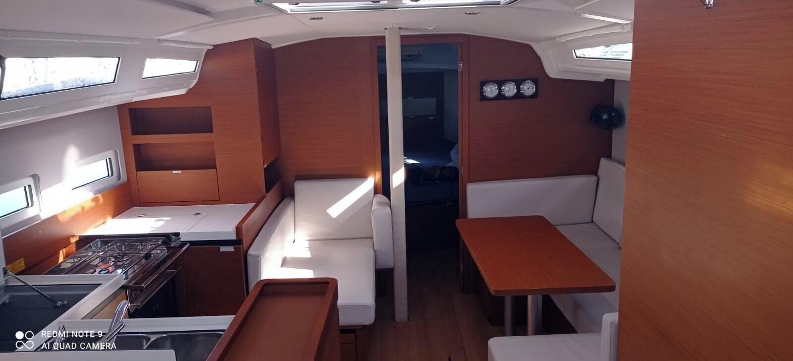 Een knus interieur met kitchenette, zithoek en een klein tafeltje.