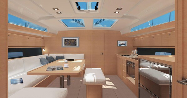 A compact, well-lit interior with a dining area, seating, and a kitchenette. - Sun-Kissed Sailing Adventure in Zadar, Croatia (Bibinje)