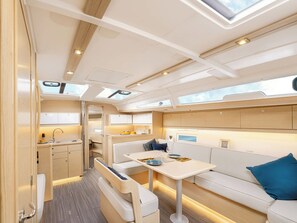 A compact, well-lit interior with a kitchenette, seating area, and skylights. - Sun-Kissed Sailing Adventure in the Ionian Islands, Lefkada (Lefkada)