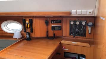 Un interno in legno con un tavolo, un telefono, una radio e un pannello di controllo.