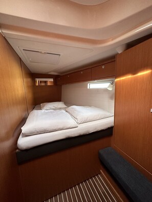 A compact, well-lit interior with a bed, storage cabinets, and a small window. - Sun-Kissed Sailing Adventure in Zadar, Croatia (Drage)