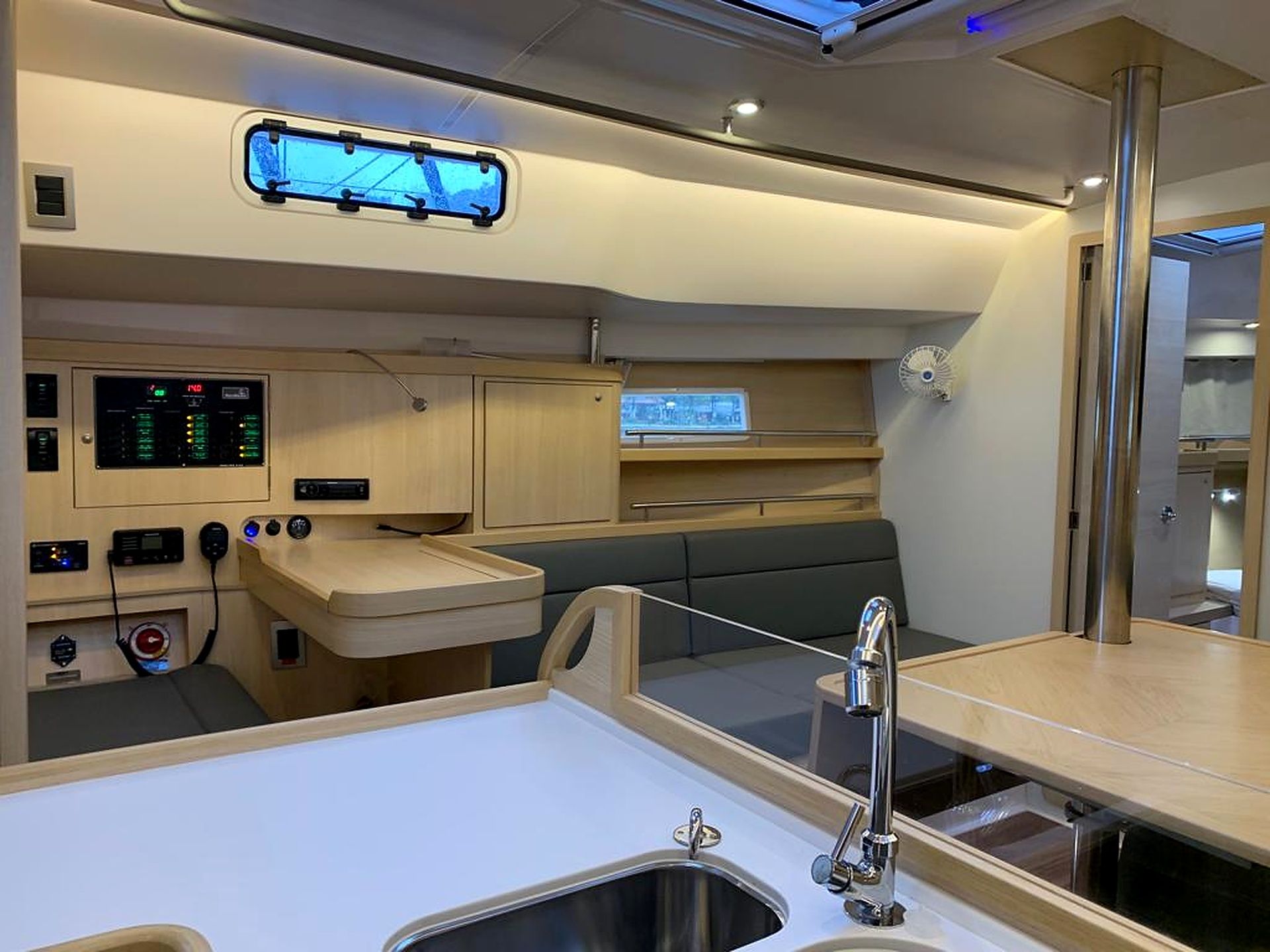 A compact kitchen with a sink, faucet, and control panel.