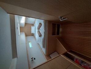 A compact room with a bed, a small window, and a built-in bench. - Sun-kissed Sailing Adventure in Split-Dalmatia, Croatia (Trogir)