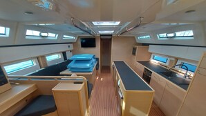 A compact interior with a bed, kitchenette, and seating area. - Sun-kissed Sailing Adventure in Split-Dalmatia, Croatia (Trogir)