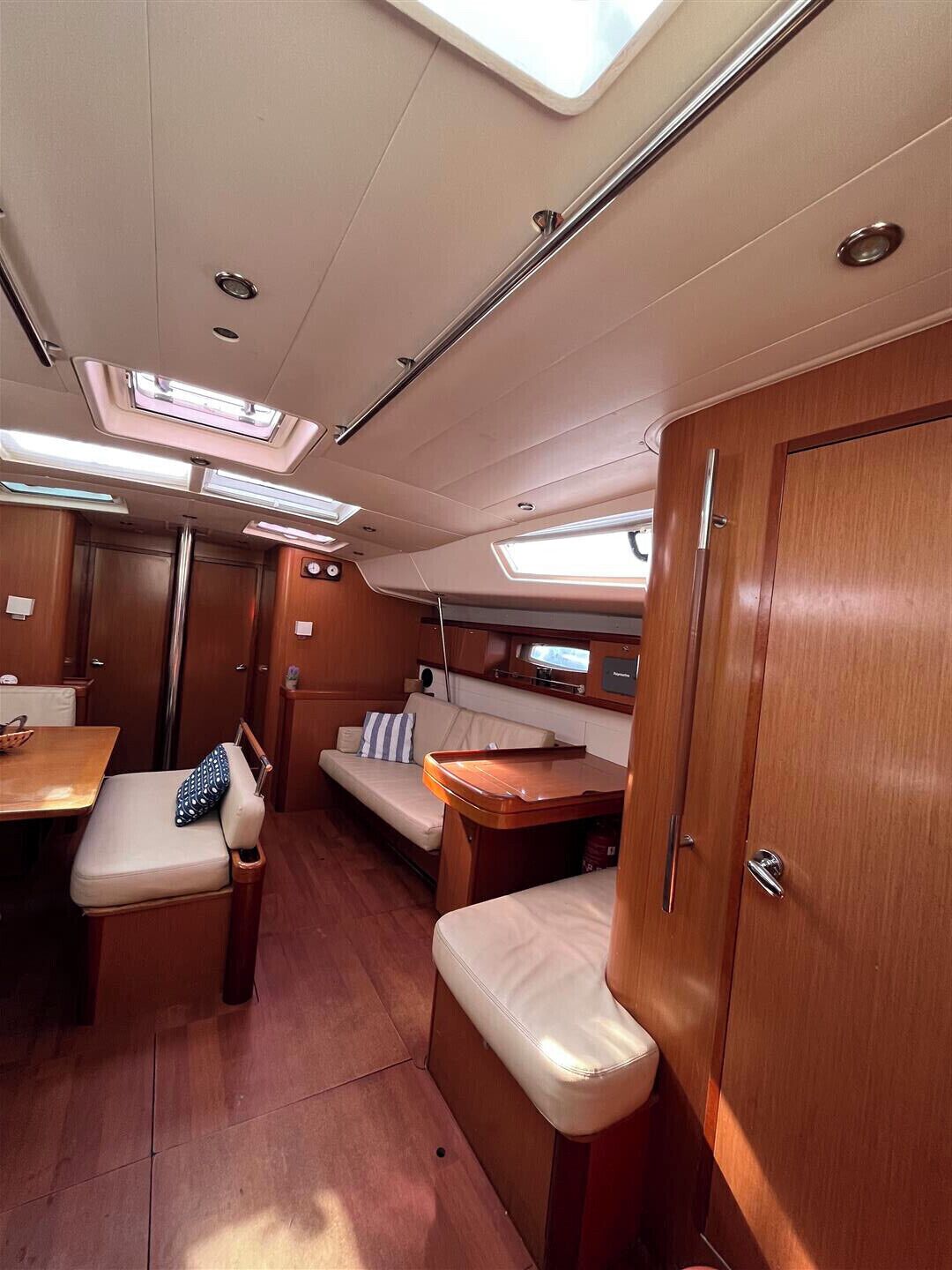 A compact interior with a dining area, seating, and a small table.