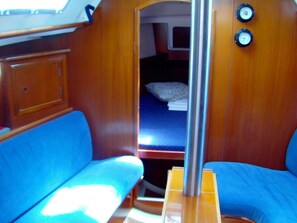 A compact interior with a bunk bed, a small table, and a bench. - Sun-kissed Sailing Adventure in Split-Dalmatia, Croatia (Trogir)