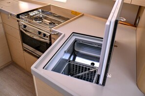 A compact kitchen with a stove, oven, and built-in dishwasher. - Sun-Kissed Sailing Adventure in Zadar, Croatia (Zadar)
