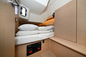 A compact bunk bed with a control panel for batteries and breakers, a window, and a wooden cabinet. - Sun-Kissed Sailing Adventure in Zadar, Croatia (Zadar)