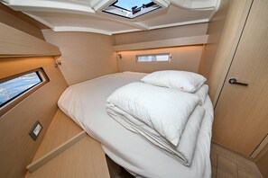 A compact, well-lit room with a bed, a window, and a door. - Sun-Kissed Sailing Adventure in Zadar, Croatia (Zadar)