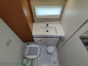 A compact bathroom with a sink, toilet, and shower. - Sun-Kissed Sailing Adventure in the Ionian Islands, Lefkada (Lefkada)