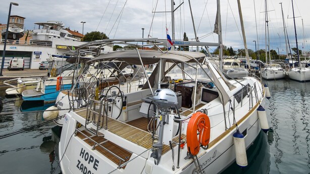 A marina with multiple boats docked, including a white boat named 'HOPE ZADAR' with a wooden deck and a lifebuoy. - Sun-Kissed Sailing Adventure in Zadar, Croatia (Zadar)