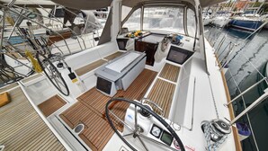 A boat deck with a steering wheel, control panel, and seating area. - Sun-Kissed Sailing Adventure in Zadar, Croatia (Zadar)
