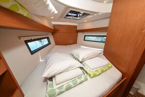 A compact, well-lit cabin with a bunk bed, small windows, and a ceiling-mounted light fixture. - Sun-Kissed Sailing Adventure in Zadar, Croatia (Zadar)