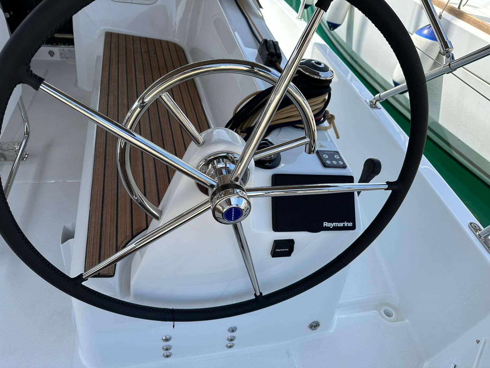 Het stuur, bedieningspaneel en een deel van het dek van een boot.
