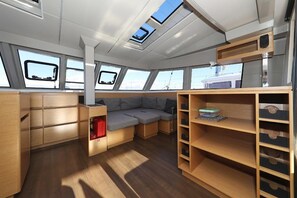 A compact interior with a sofa, storage shelves, and skylights. - Sun-Kissed Sailing Adventure in Istria, Croatia (Pula)
