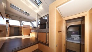 A compact, well-lit interior with a kitchenette, seating area, and a small closet. - Sun-Kissed Sailing Adventure in Istria, Croatia (Pula)