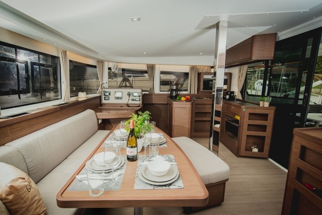 A modern interior with a dining area, seating, and a kitchen.
