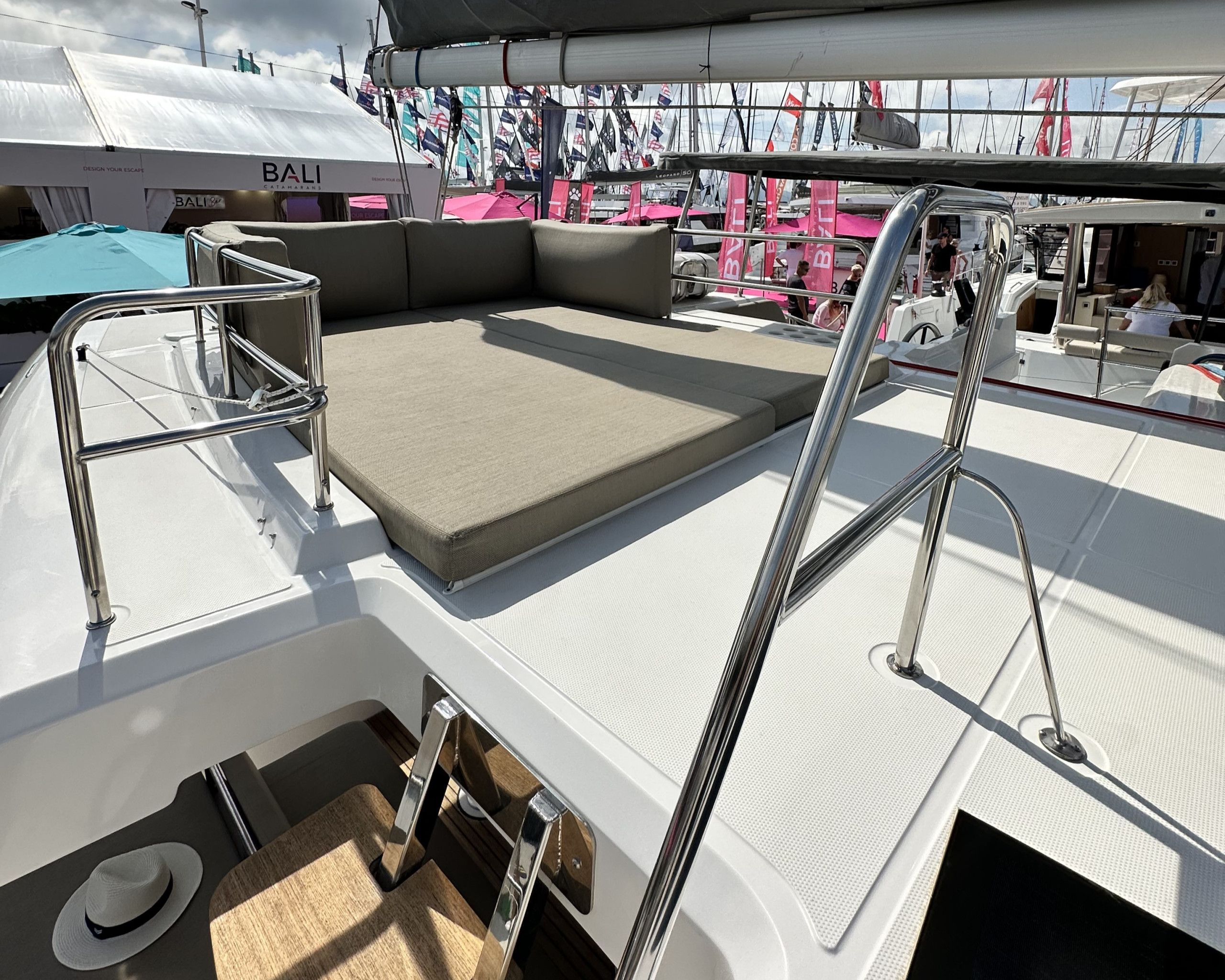 A boat deck with a seating area, metal railings, and a covered section.