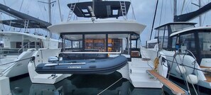 A yacht with a covered deck area, a seating arrangement, and a visible cabin with windows. - Sun-Kissed Sailing Adventure in Islas Sarónicas (Alimos)