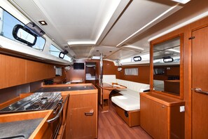 A compact galley with a stove, a small sink, and a bench. - Sun-Kissed Sailing Adventure in Zadar, Croatia (Bibinje)