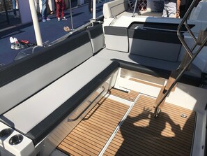 A boat deck with seating, a small table, and a railing. - Sun-Kissed Sailing Adventure in Zadar, Croatia (Zadar)
