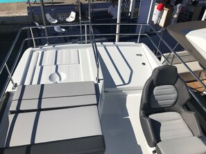 A boat's deck with seating, a steering wheel, and a control panel. - Sun-Kissed Sailing Adventure in Zadar, Croatia (Zadar)