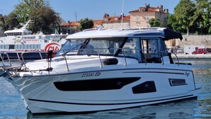 A white motor yacht with a cabin, a windshield, and a registration number. - Sun-Kissed Sailing Adventure in Zadar, Croatia (Zadar)