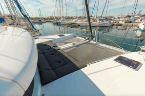 A marina with multiple sailboats docked.