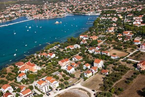 An aerial view of a coastal town with houses, a marina, and boats. - Sun-Kissed Sailing Adventure in Zadar, Croatia (Bibinje)
