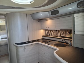 A compact kitchen with a sink, cabinets, and a countertop. - Sun-Kissed Sailing Adventure in Sibenik, Croatia (Primošten)
